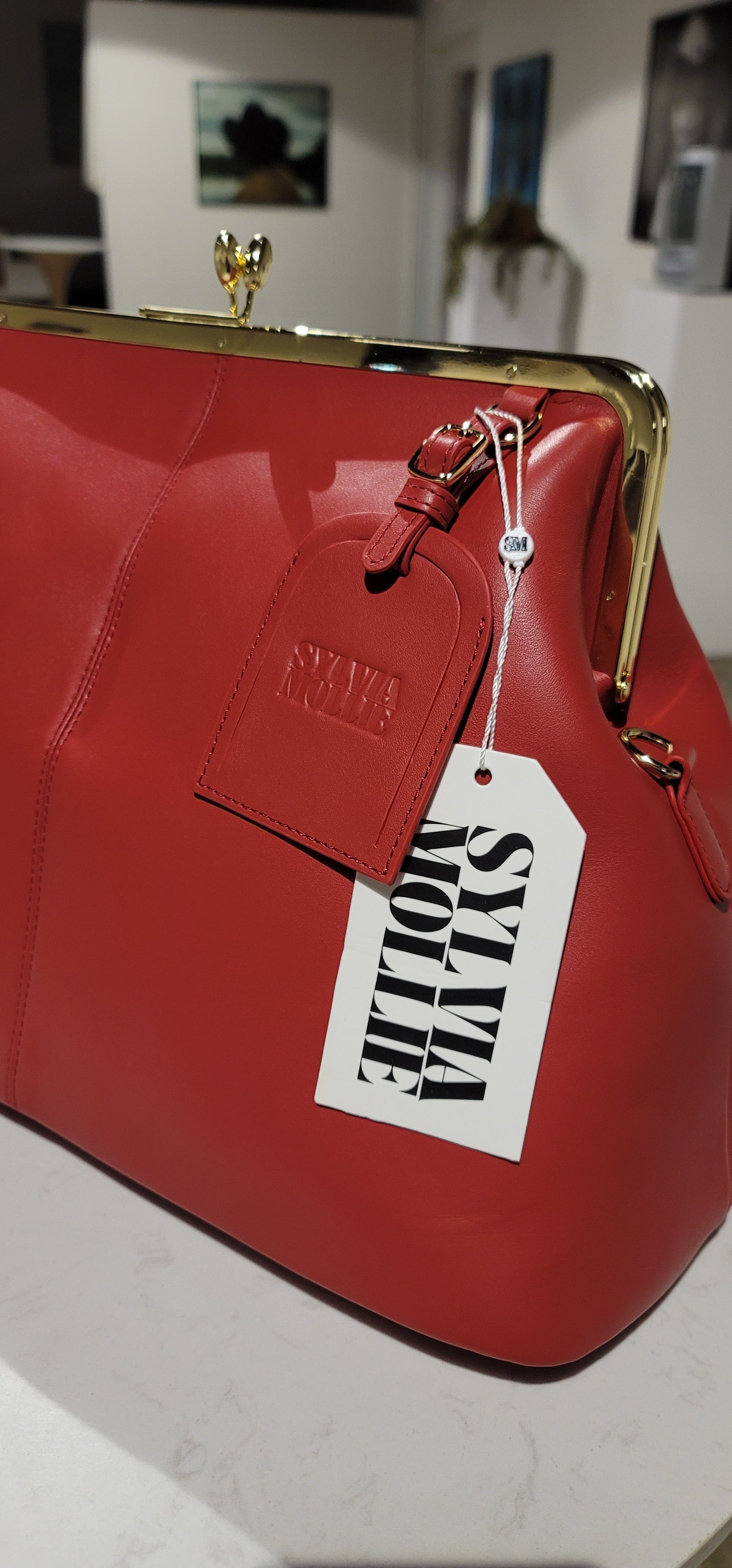 Red leather Fannie Bag showing the kiss-lock frame