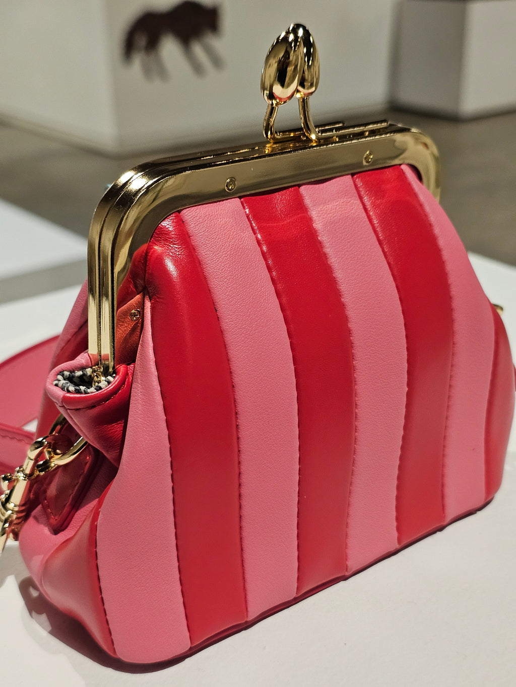 Lil Fannie in bright red with a gold chain handle