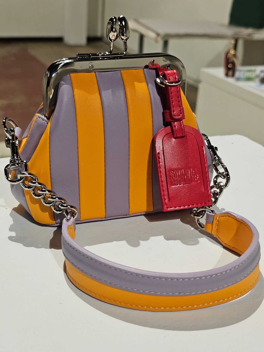 The Lil Fannie mini bag in hot yellow and soft lilac leather with a gold kiss-lock frame