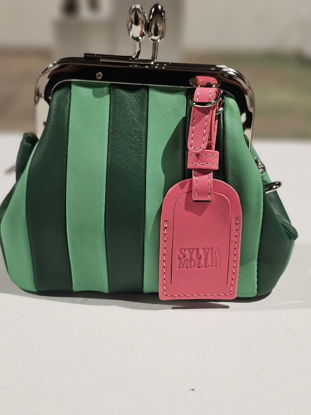The Sylvia Mollie Lil Fannie in green with a leather hangtag
