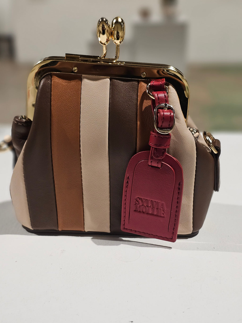 Lil Fannie mini bag with a dark red hangtag