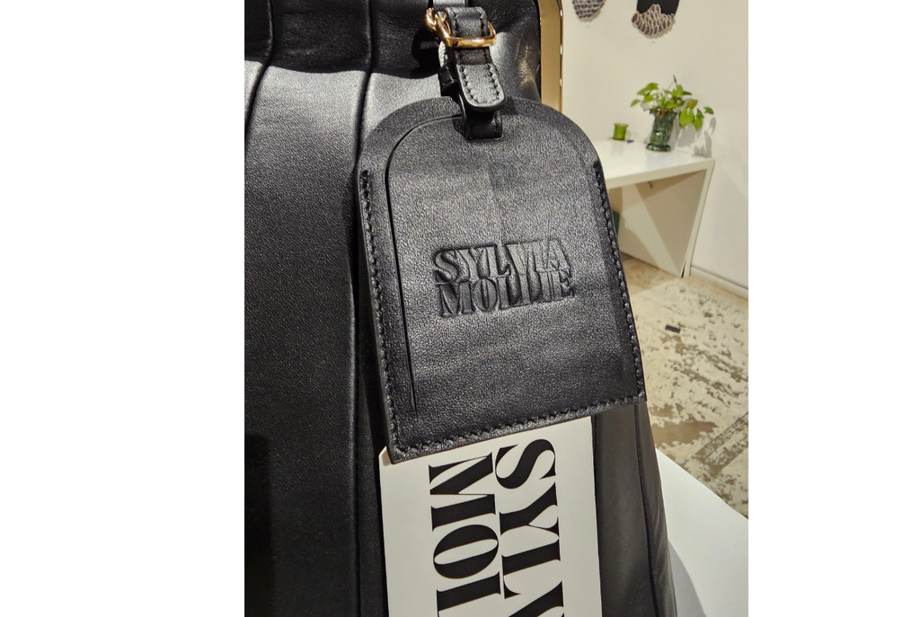 Black panelled leather Fannie Bag with an embossed hangtag
