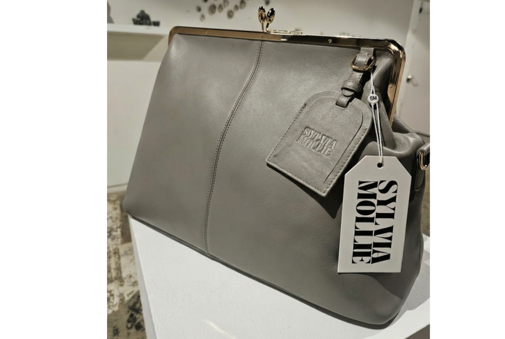 Grey leather kiss-lock handbag by Sylvia Mollie