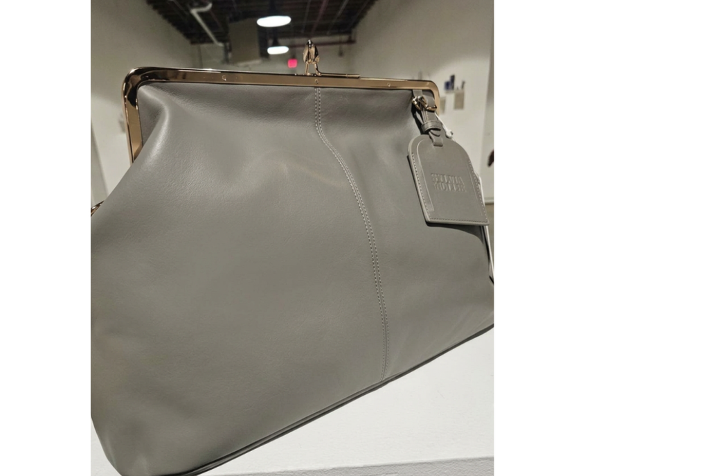 Grey kiss-lock leather handbag with a gold-tone frame