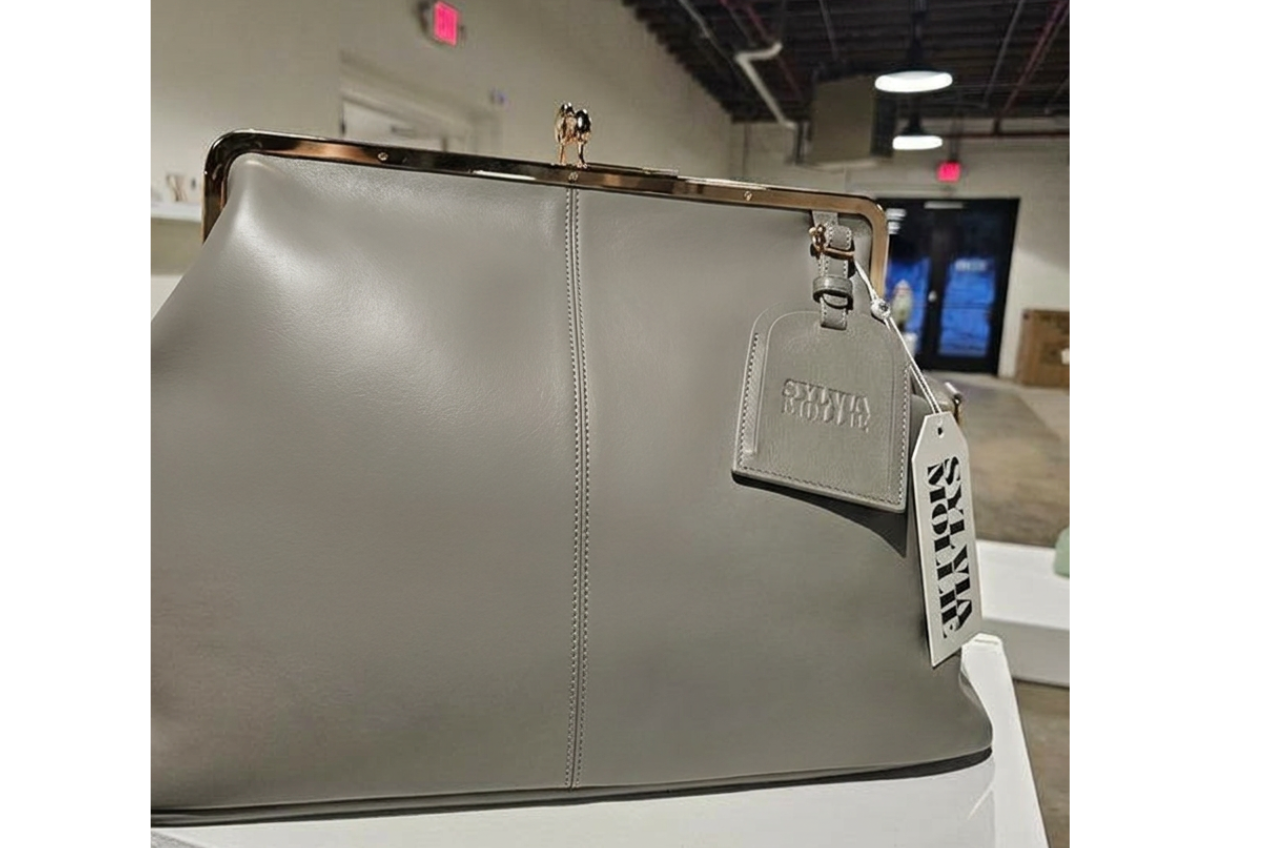 Grey leather Fannie Bag with a matching embossed hangtag