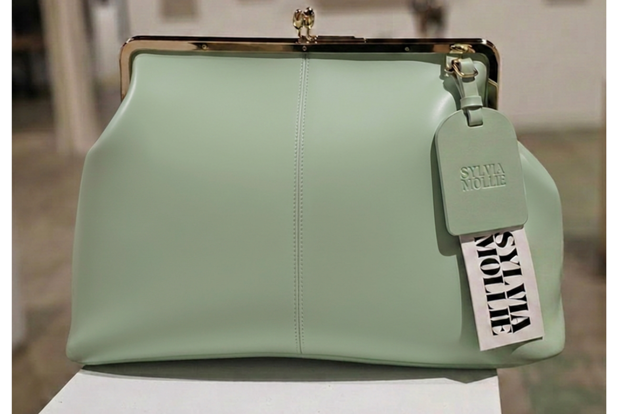 The Fannie Bag in soft mint leather with a gold-tone kiss-lock frame and embossed hangtag
