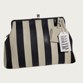 The Fannie Bag in ecru and black striped leather with a silver kiss-lock frame and embossed hangtag
