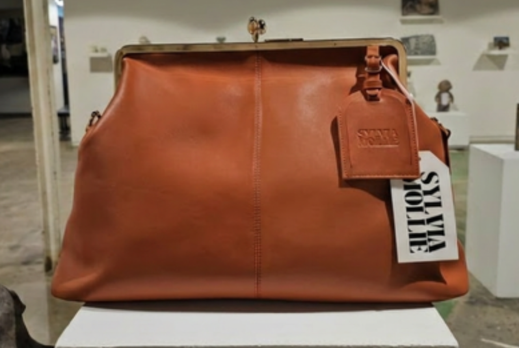 The Fannie Bag in cognac with a matching embossed hangtag