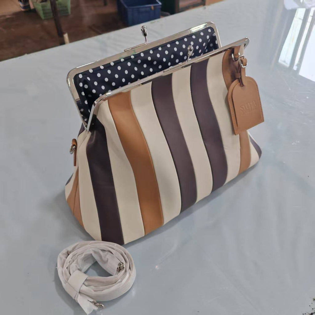 The Fannie Bag in Choco Mix with an embossed leather hangtag